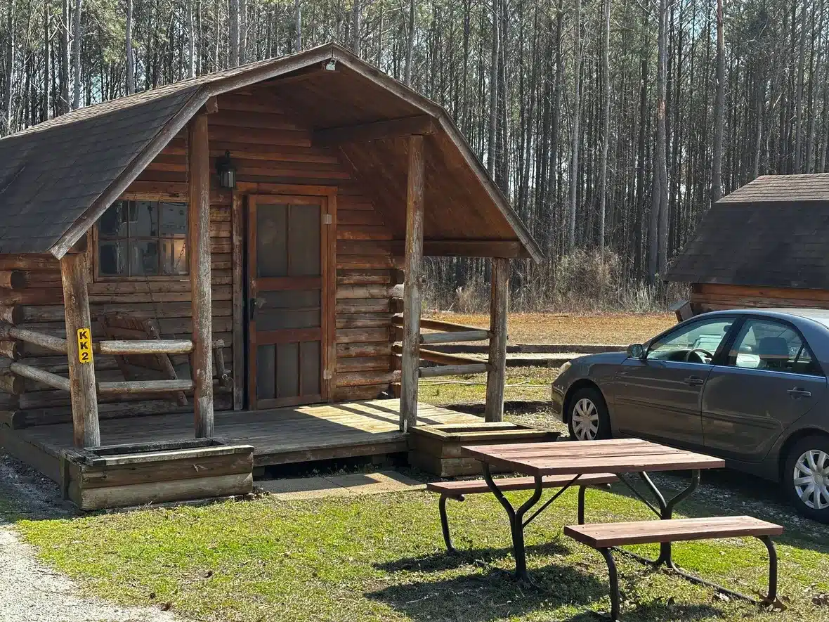 Wooden cabin with front porch at Atlanta South RV Resort