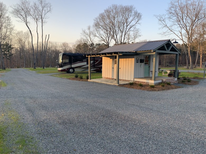 Bathhouse exterior and nearby RV at 4 County RV Park & Campground
