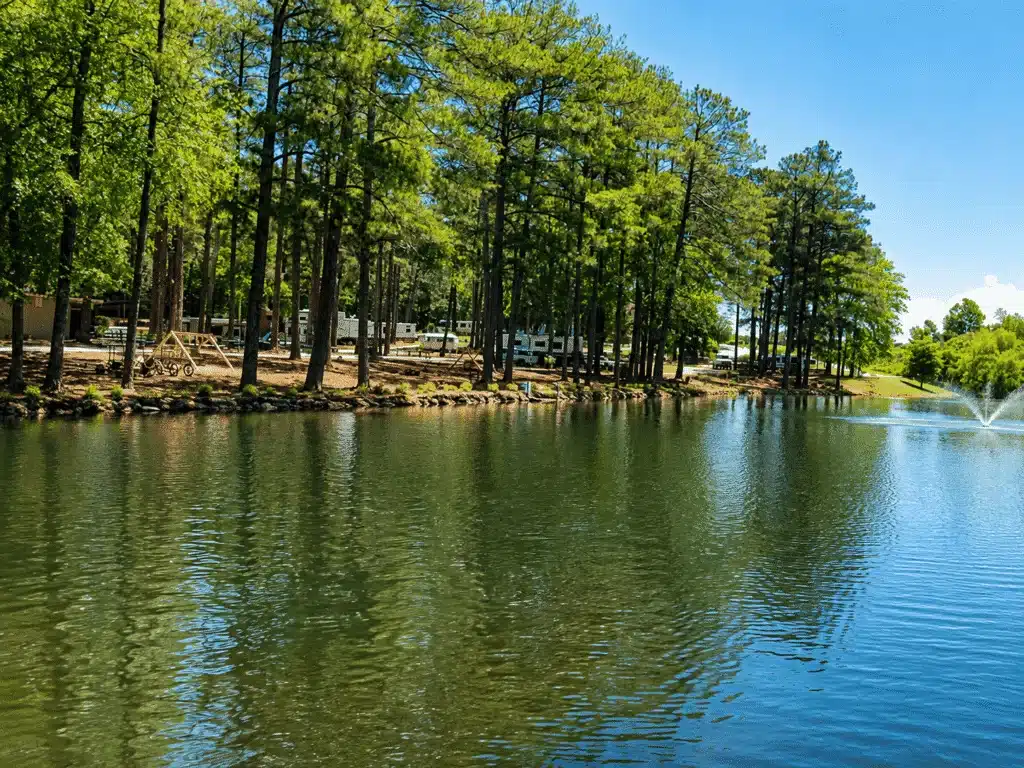 RV sites at Forsyth Station RV Resort in Forsyth, Georgia, surrounded by wooded campground grounds.
