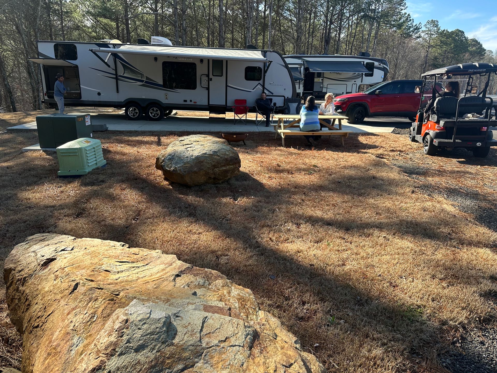 Picnic table and outdoor space beside an RV at Apple Country RV Resort