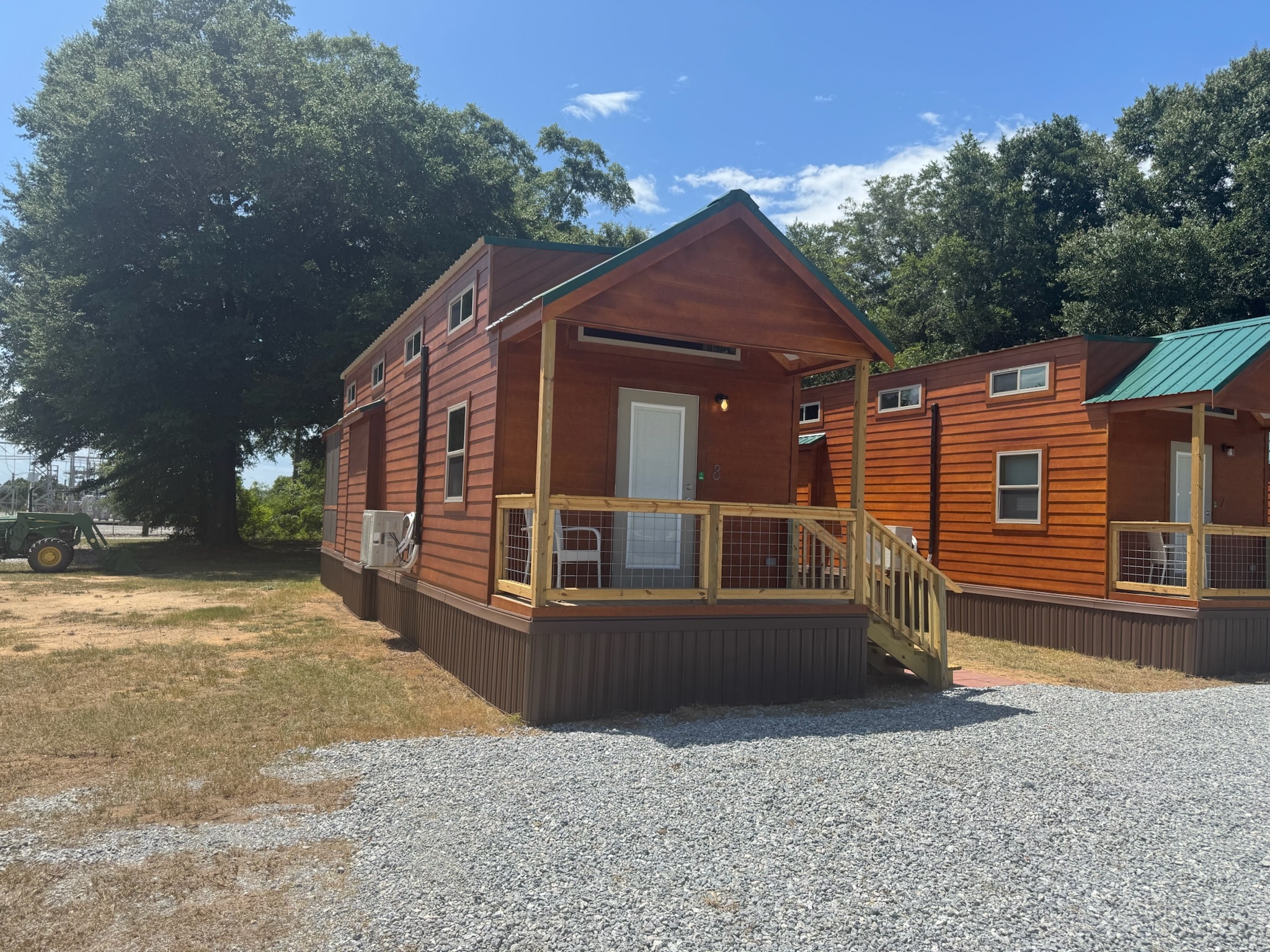 Cabin with a covered front porch at Camp David RV Resort