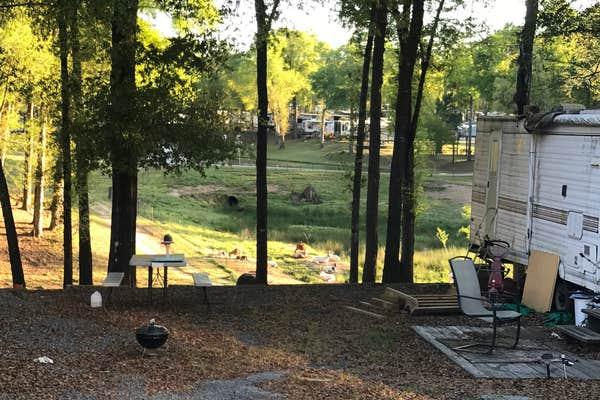 RV site surrounded by trees at Fair Harbor RV Park & Campground