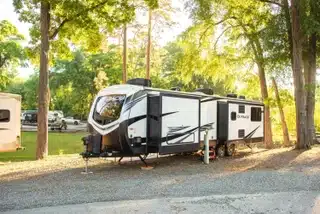 Wooded RV site at Fair Harbor RV Park & Campground