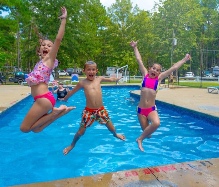 Children enjoying the swimming pool at Jellystone Park Cochran