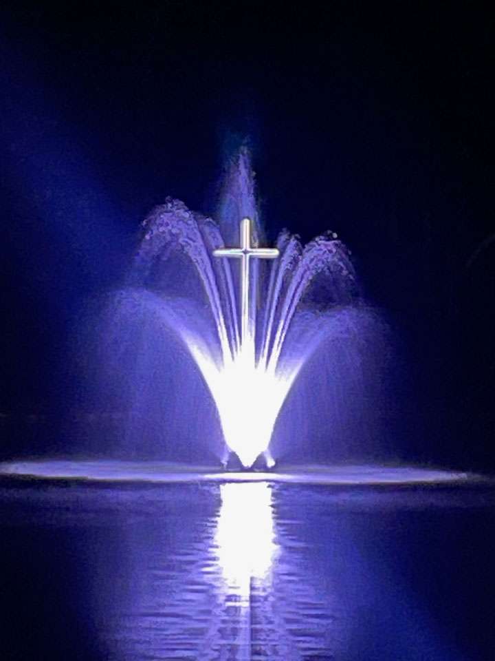 Pond fountain and cross at Leisure Acres RV Resort