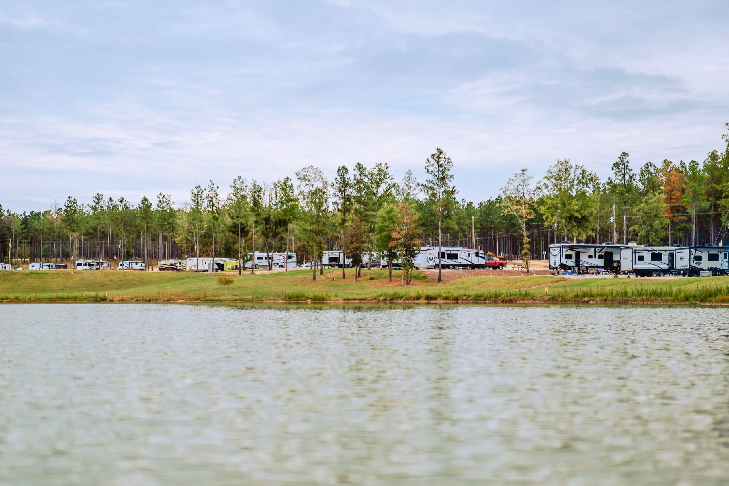 RV camping beside a pond at Little River RV Park at Durhamtown