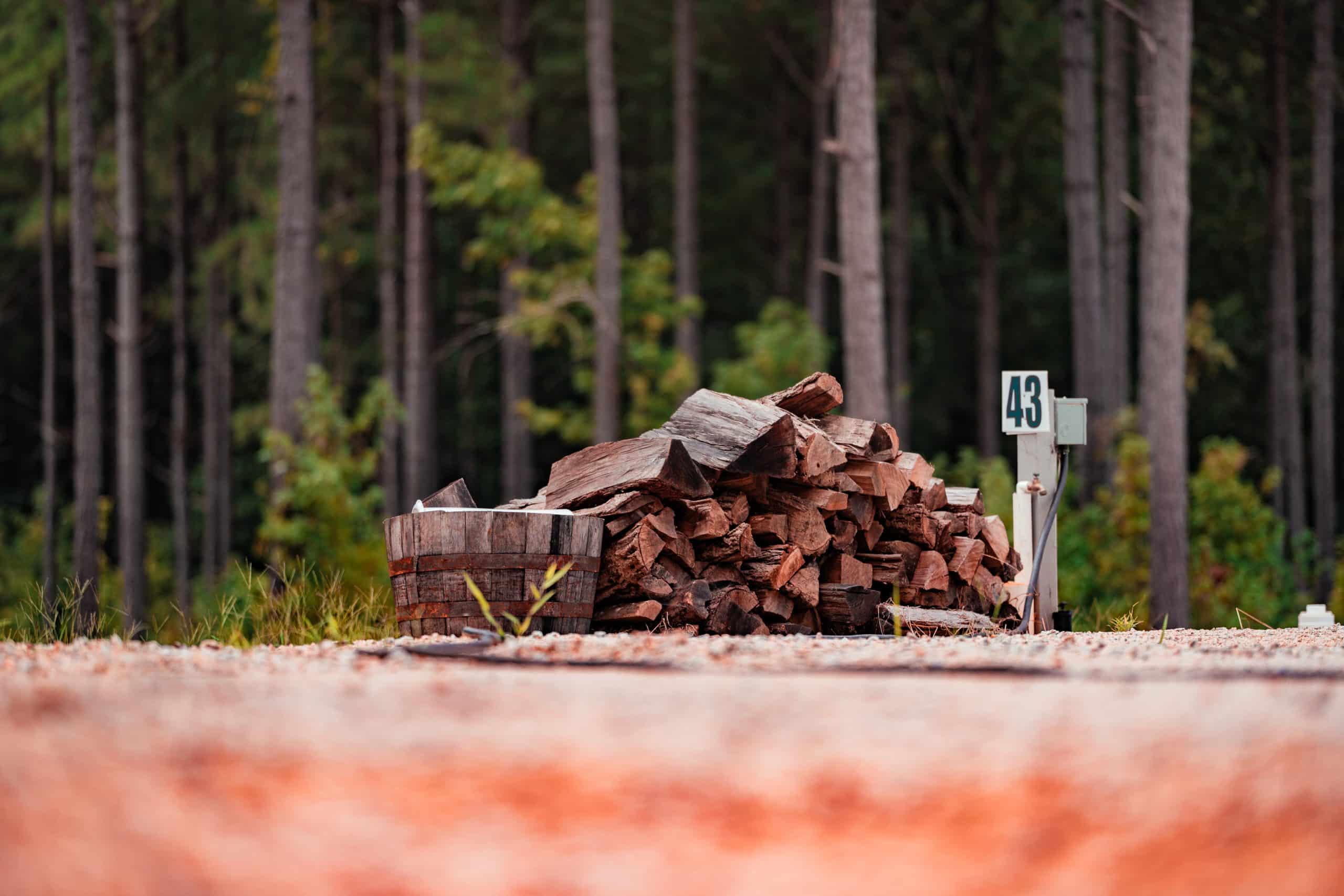Firewood beside an RV site at Little River RV Park at Durhamtown