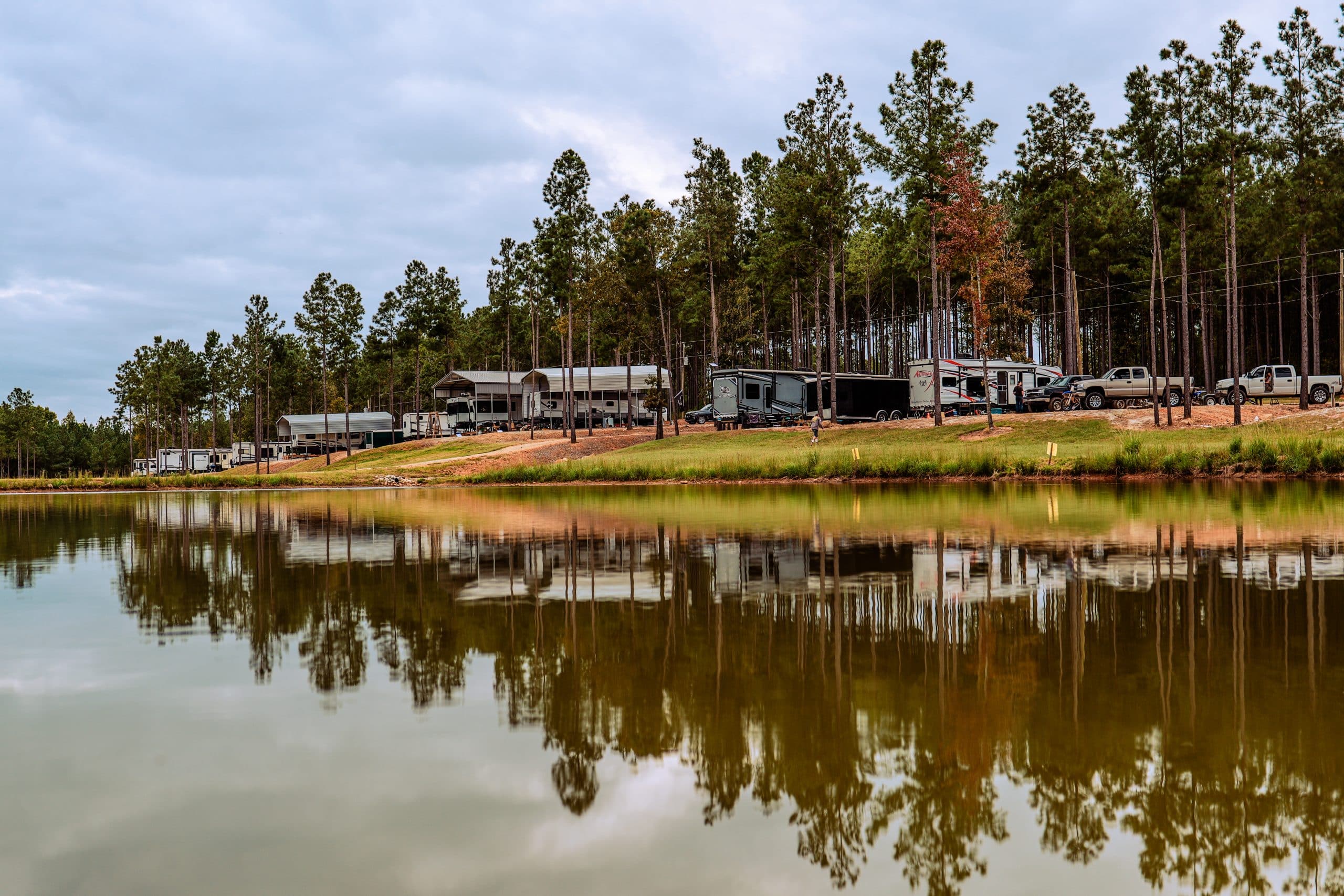 RV campground reflected in a pond at Little River RV Park at Durhamtown