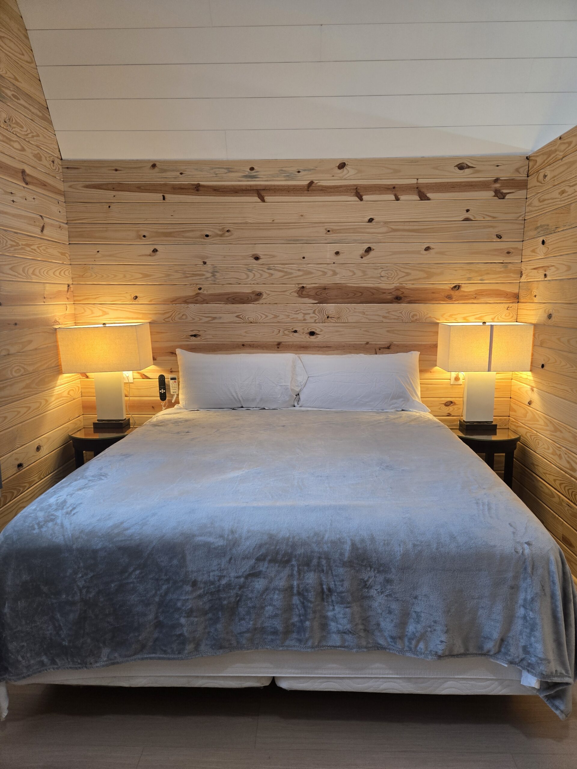 Wood-paneled bedroom at Rusty's Retreat