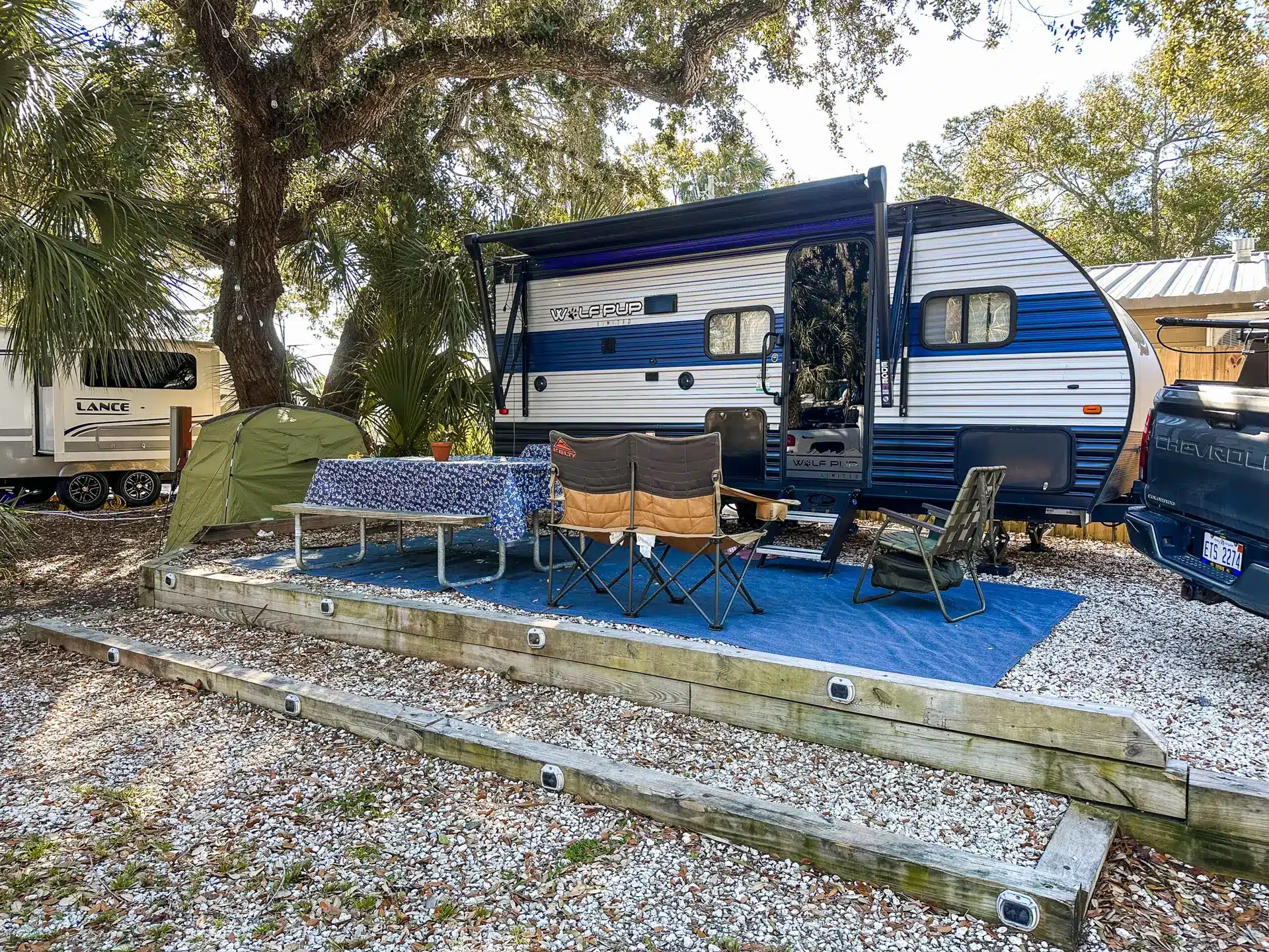Full-hookup RV campsite beneath the live oaks at River's End Campground & RV Park
