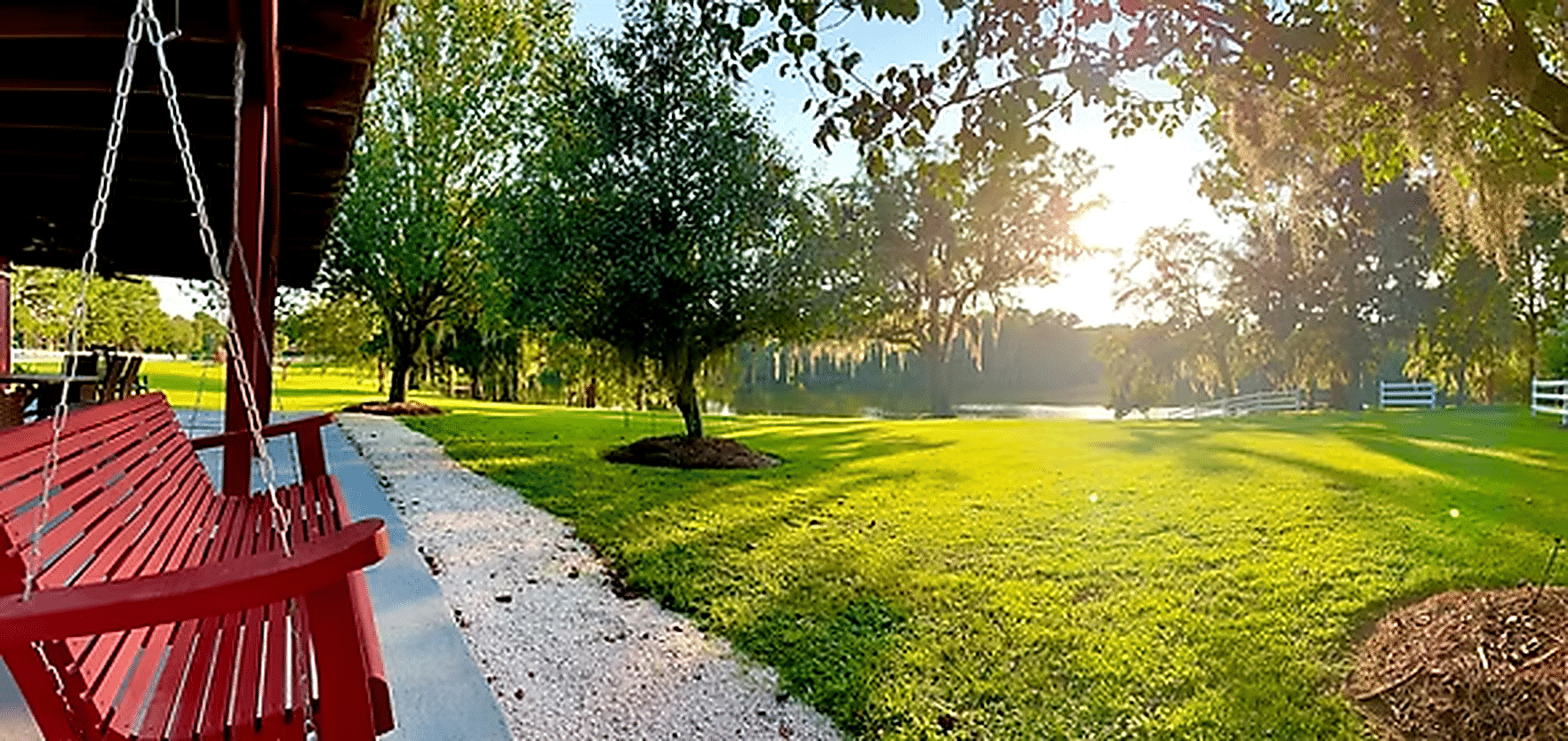 Porch swing overlooking the lake at Red Gate Farms RV Resort