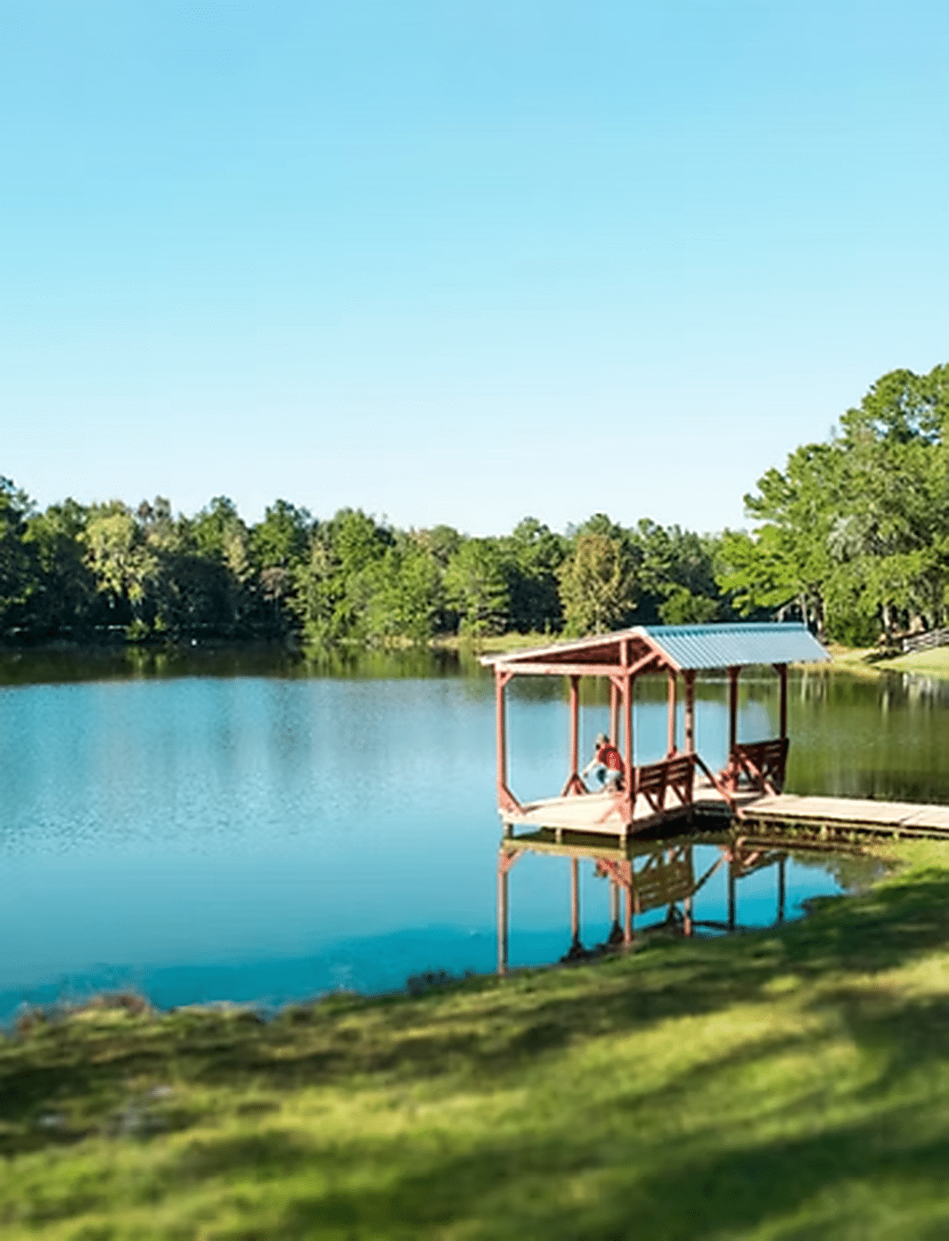 Lake and waterfront dock at Red Gate Farms RV Resort