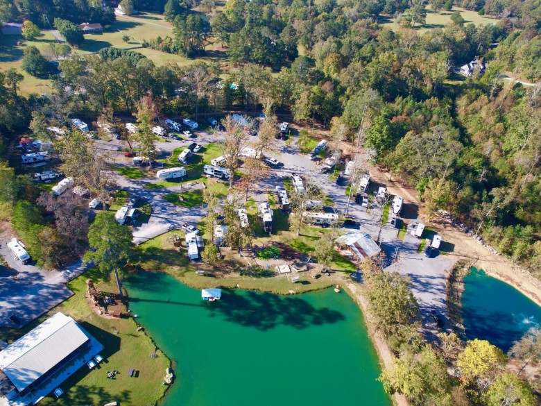 Aerial view of RV sites and a fishing pond at Scenic City RV Campground