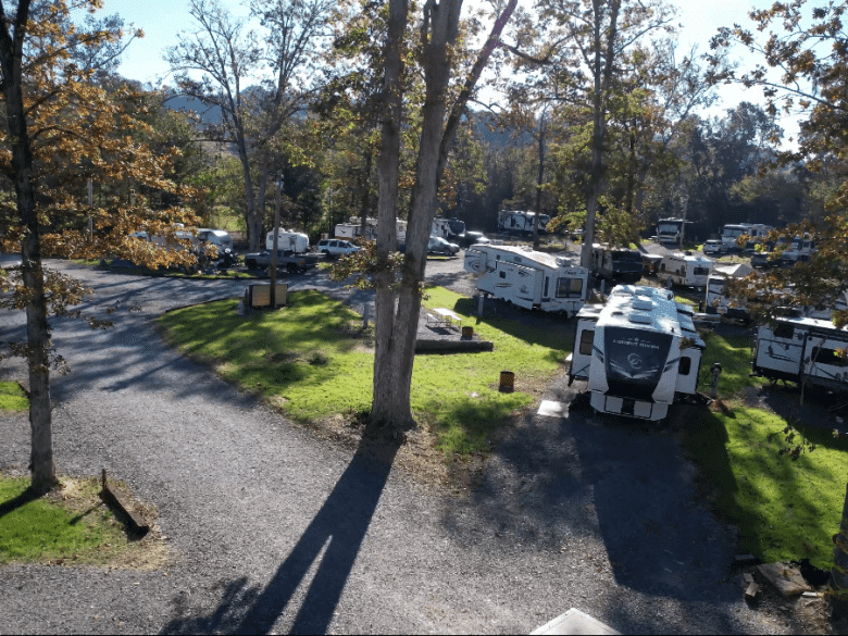 RV campsites beneath mature trees at Scenic City RV Campground