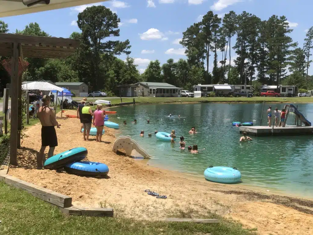 Guests swimming and relaxing at Shine Lake at Beaver Run RV Park