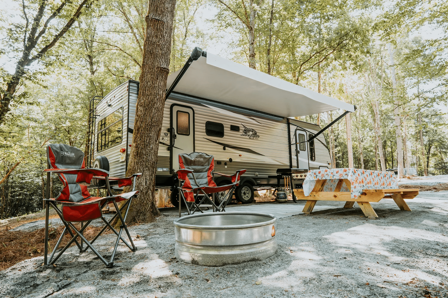 RV camping among trees at Ted & Tracy's RV Campground