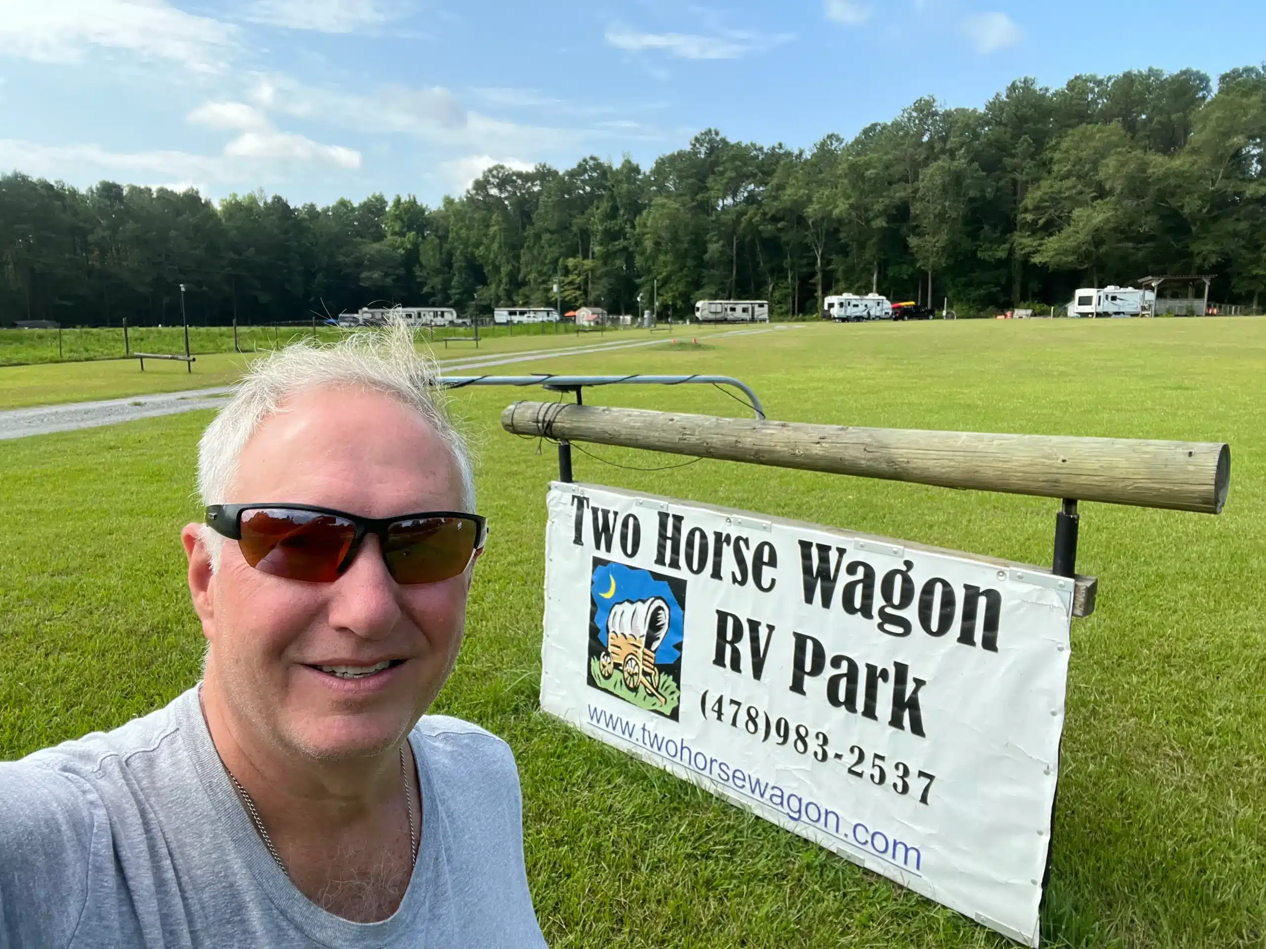 Visitor beside the Two Horse Wagon RV Park sign