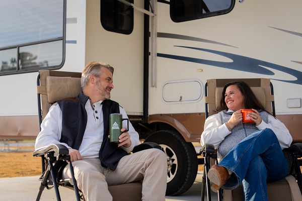 Family relaxing at an RV site at Wild Adventures Safari Campground