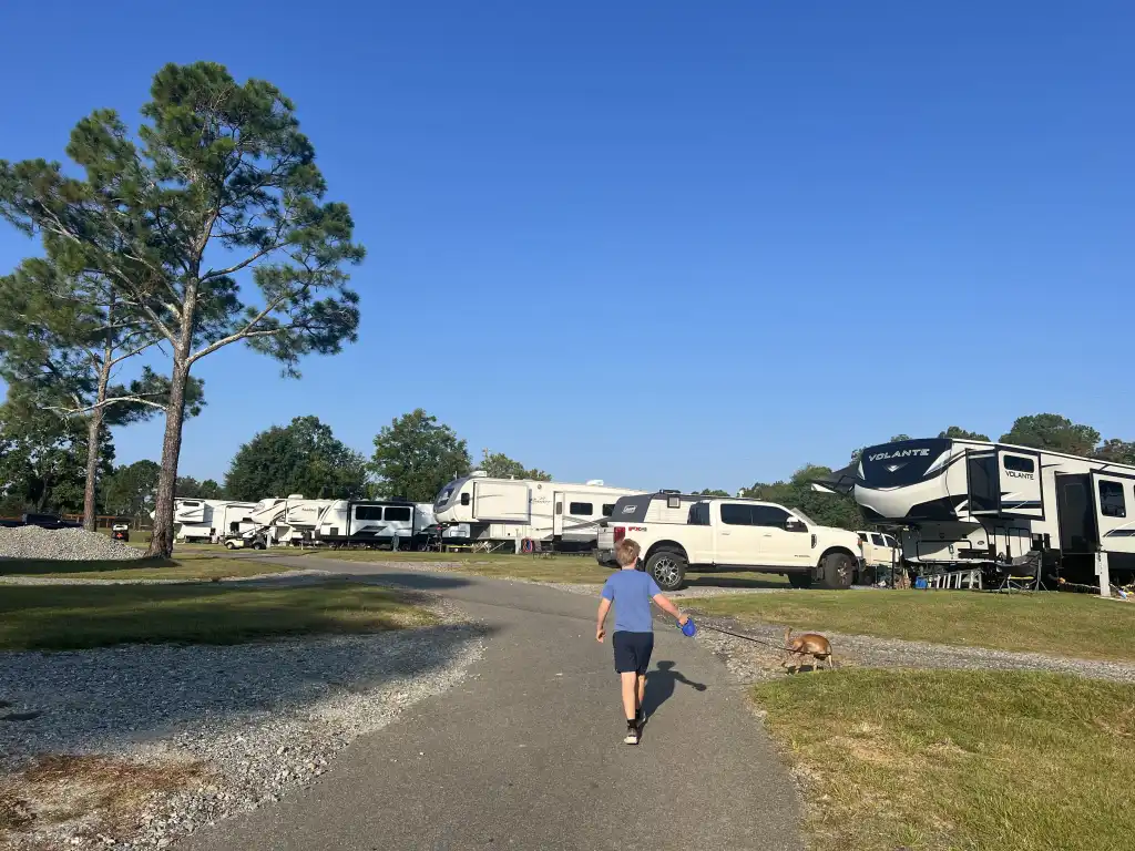 Guest walking a dog through Wanee Lake Golf & RV Resort