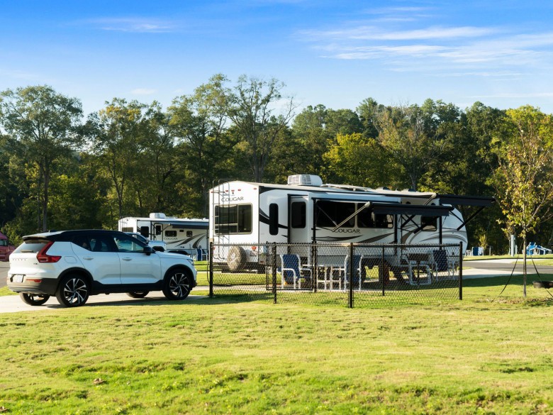 Paw Pen RV site with a private fenced pet area at Winding Waters Riverfront RV Resort
