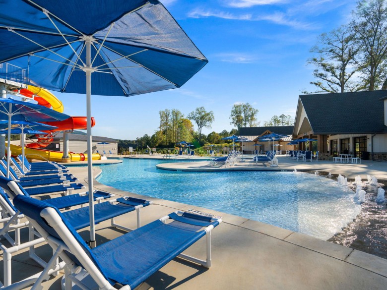 Poolside seating and waterslides at Winding Waters Riverfront RV Resort