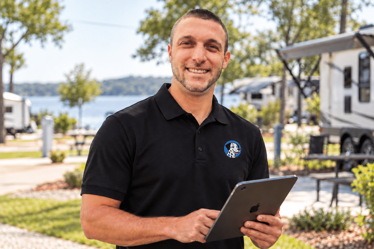 Smiling campground host holding a tablet